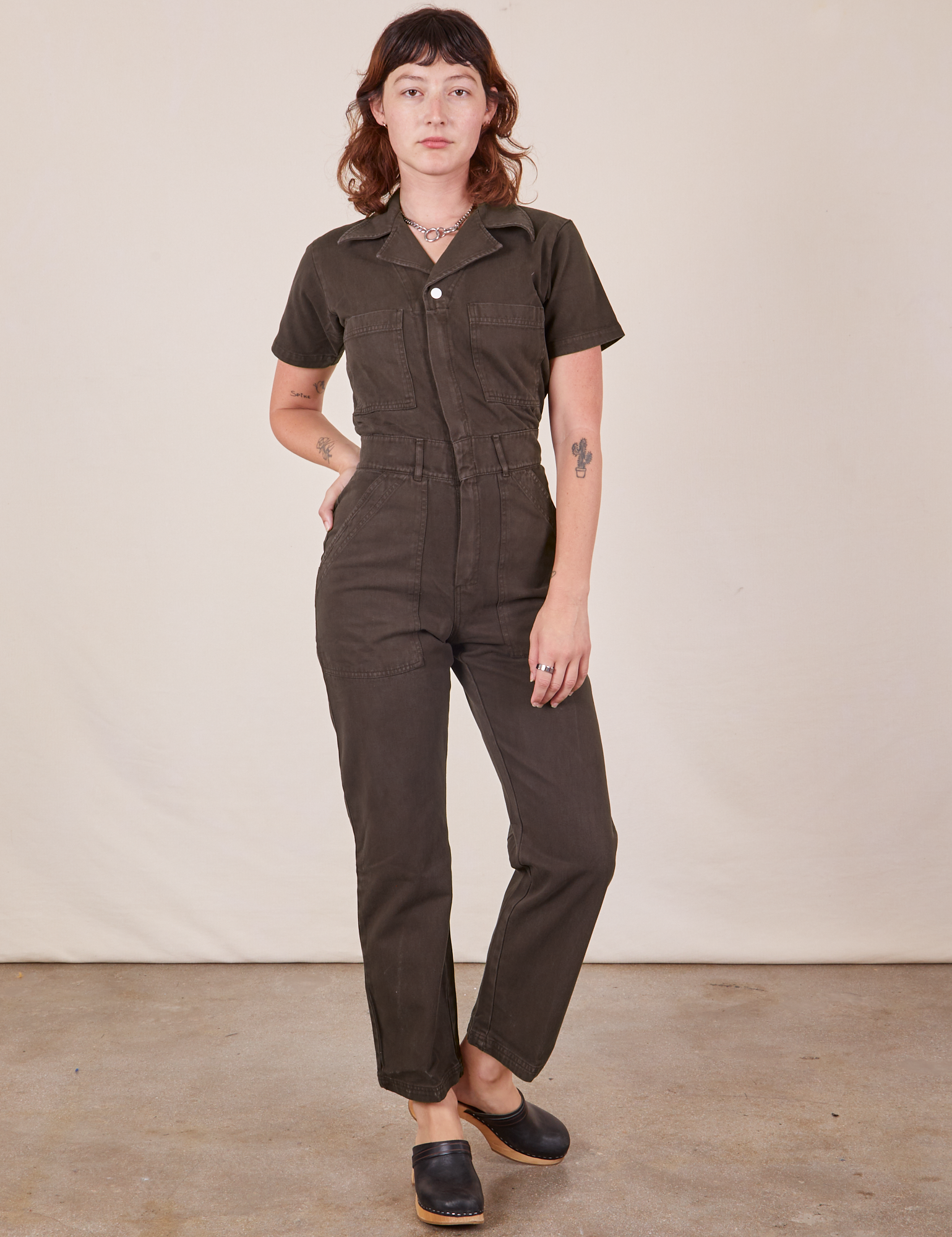 Alex is wearing Short Sleeve Jumpsuit in Espresso Brown