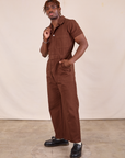 Short Sleeve Jumpsuit in Fudgesicle Brown front angled view on Issac