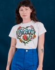 Alex is wearing Chicago Tourist Tee tucked into royal blue Western Pants