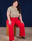Ashley is wearing Off-White Strawberry Pantry Button-Up and mustang red Western Pants