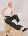 Madeline is wearing Heavyweight Trousers in Swamp Green and Sleeveless Turtleneck in vintage tee off-white
