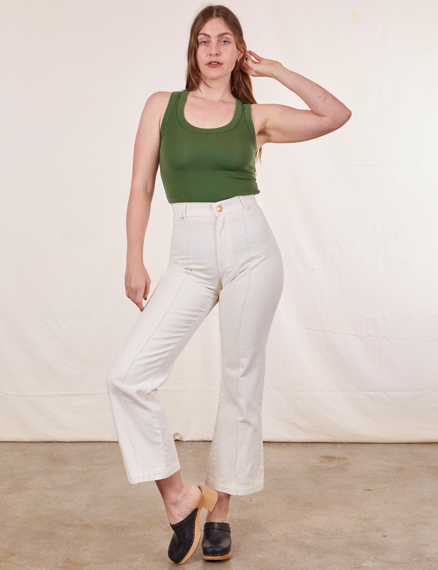 Allison is wearing XXS Tank Top in Dark Emerald Green paired with vintage tee off-white Western Pants