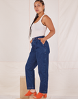 Side view of Denim Trouser Jeans in Dark Wash and Tank Top in vintage tee off-white worn by Gabi