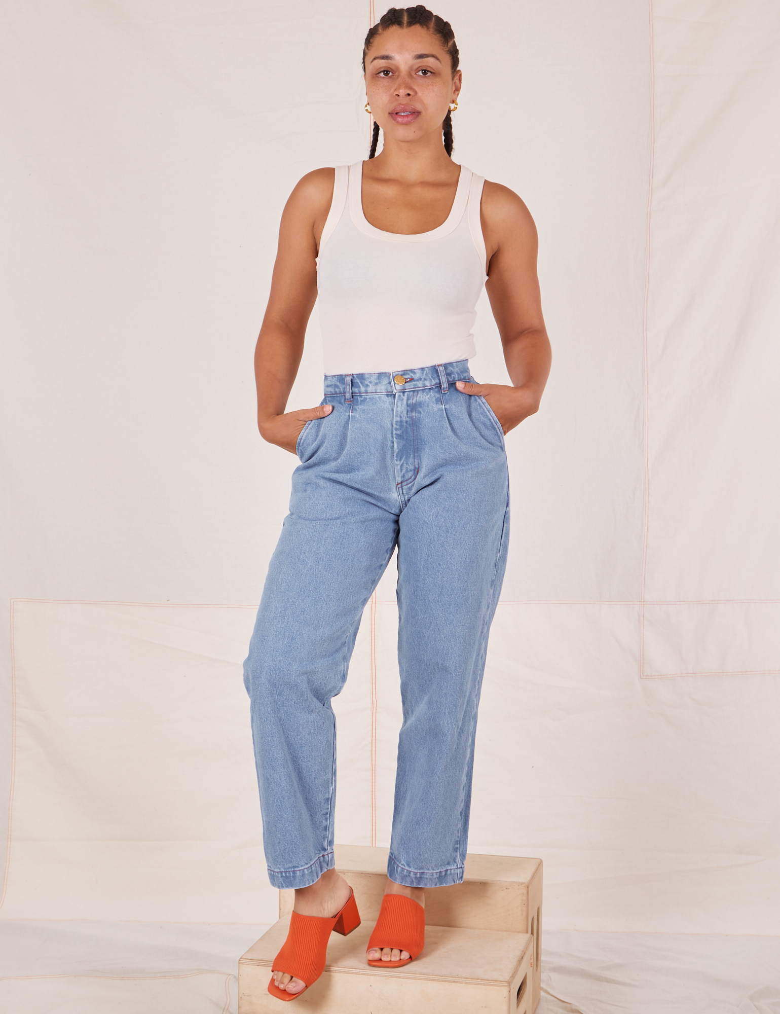 Gabi is 5&#39;7&quot; and wearing XXS Denim Trouser Jeans in Light Wash paired with Tank Top in vintage tee off-white
