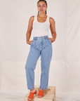 Gabi is 5'7" and wearing XXS Denim Trouser Jeans in Light Wash paired with Tank Top in vintage tee off-white