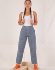 Gabi is 5'7" and wearing XXS Denim Trouser Jeans in Railroad Stripe paired with Tank Top in vintage tee off-white