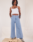 Jerrod is wearing Indigo Wide Leg Trousers in Light Wash and vintage off-white Cami