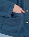Close up of Juliet's hand in the front pocket of Denim Work Jacket in French Blue