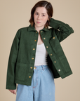 Hana is 5'3" and wearing P Denim Work Jacket in Swamp Green