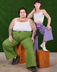 Sam is wearing Overdyed Wide Leg Trousers in Gross Green and Cropped Cami in vintage tee off-white. Alex is standing behind them wearing Overdyed Wide Leg Trousers in Faded Grape