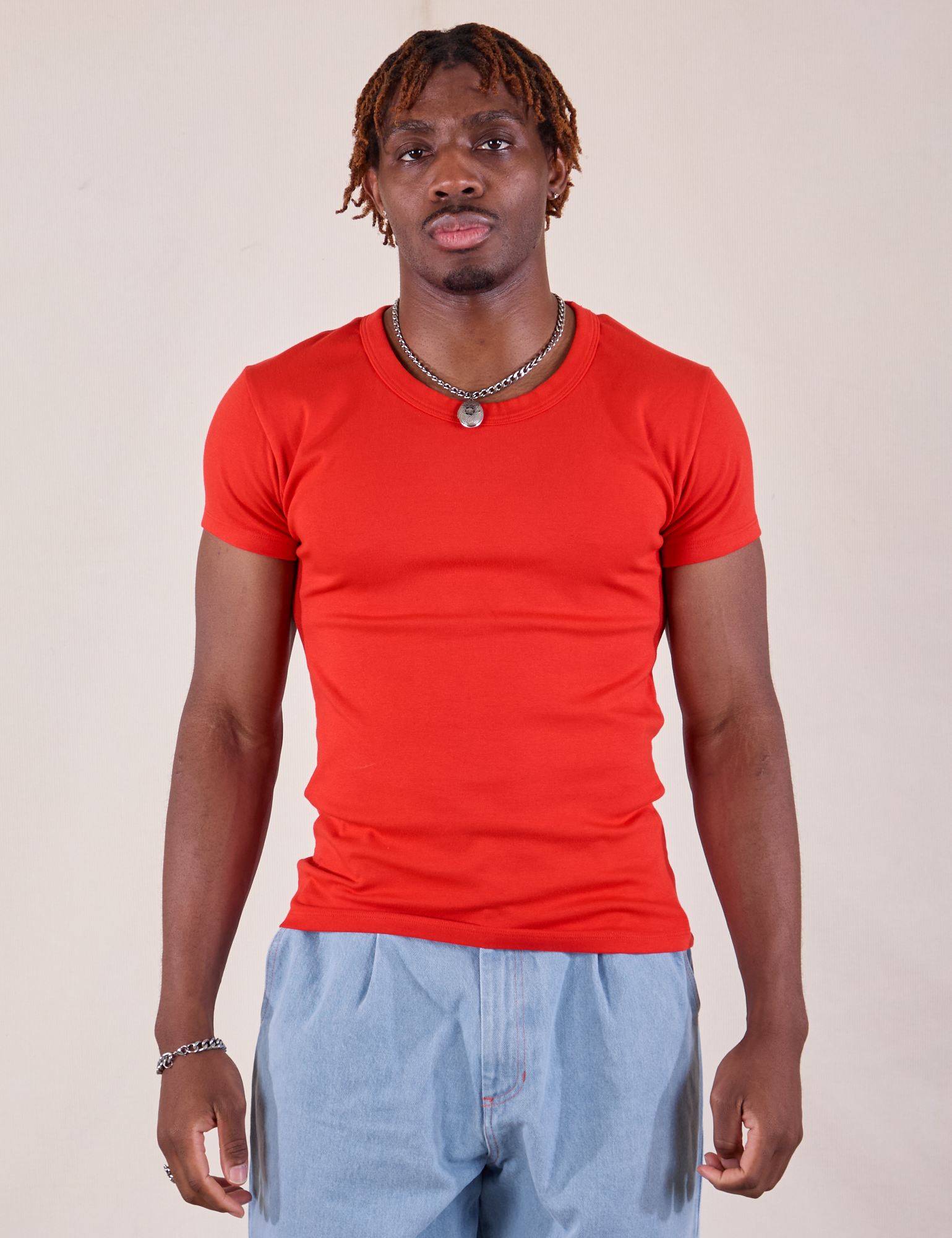 Issac is 5'10" and wearing L Baby Tee in Mustang Red
