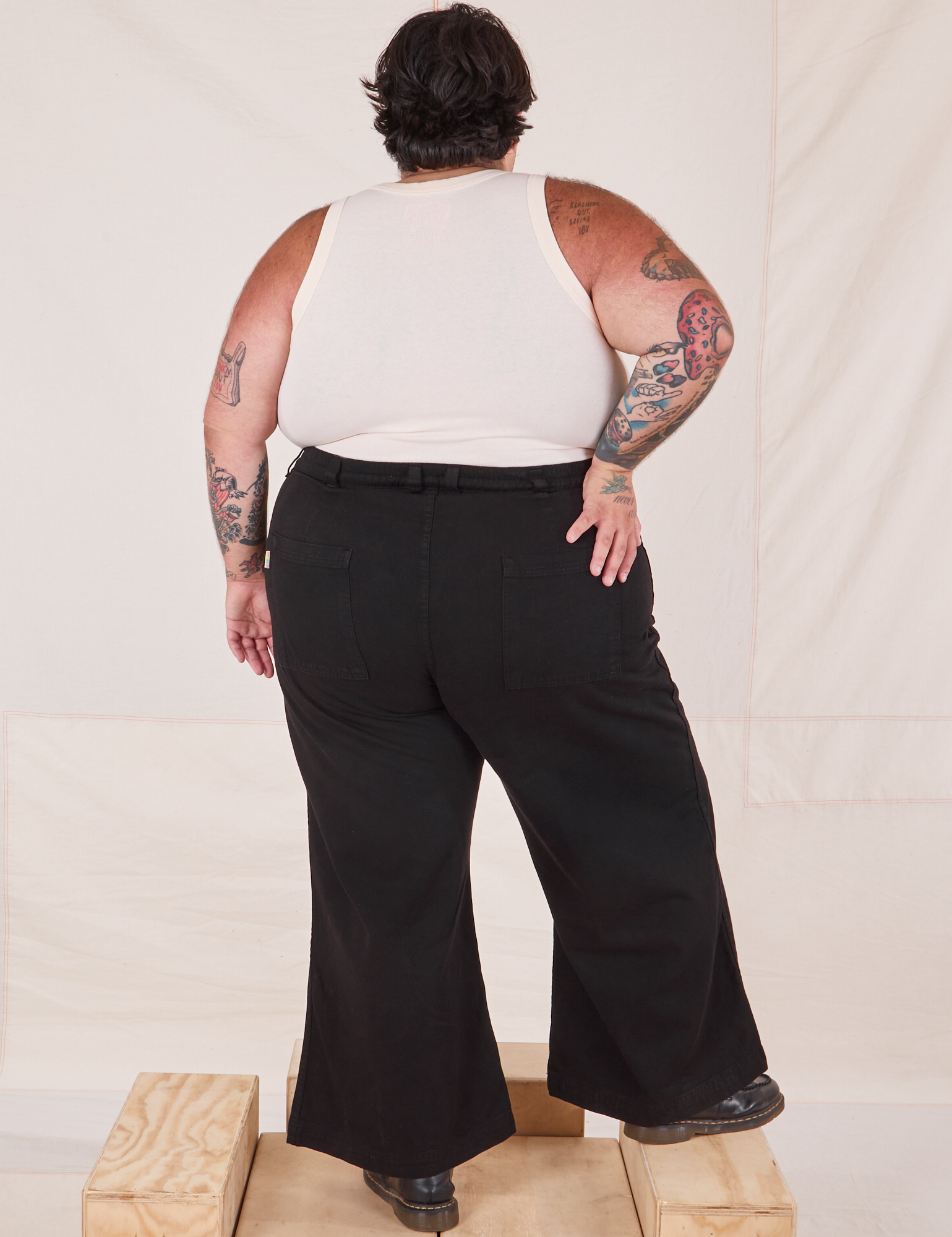 Back view of Bell Bottoms in Basic Black and vintage off-white Tank Top on Sam