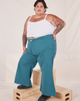 Angled view of Bell Bottoms in Marine Blue and Cropped Cami in vintage tee off-white on Sam