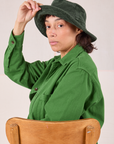 Tiara is wearing Wide Brim Denim Bucket Hats in Swamp Green