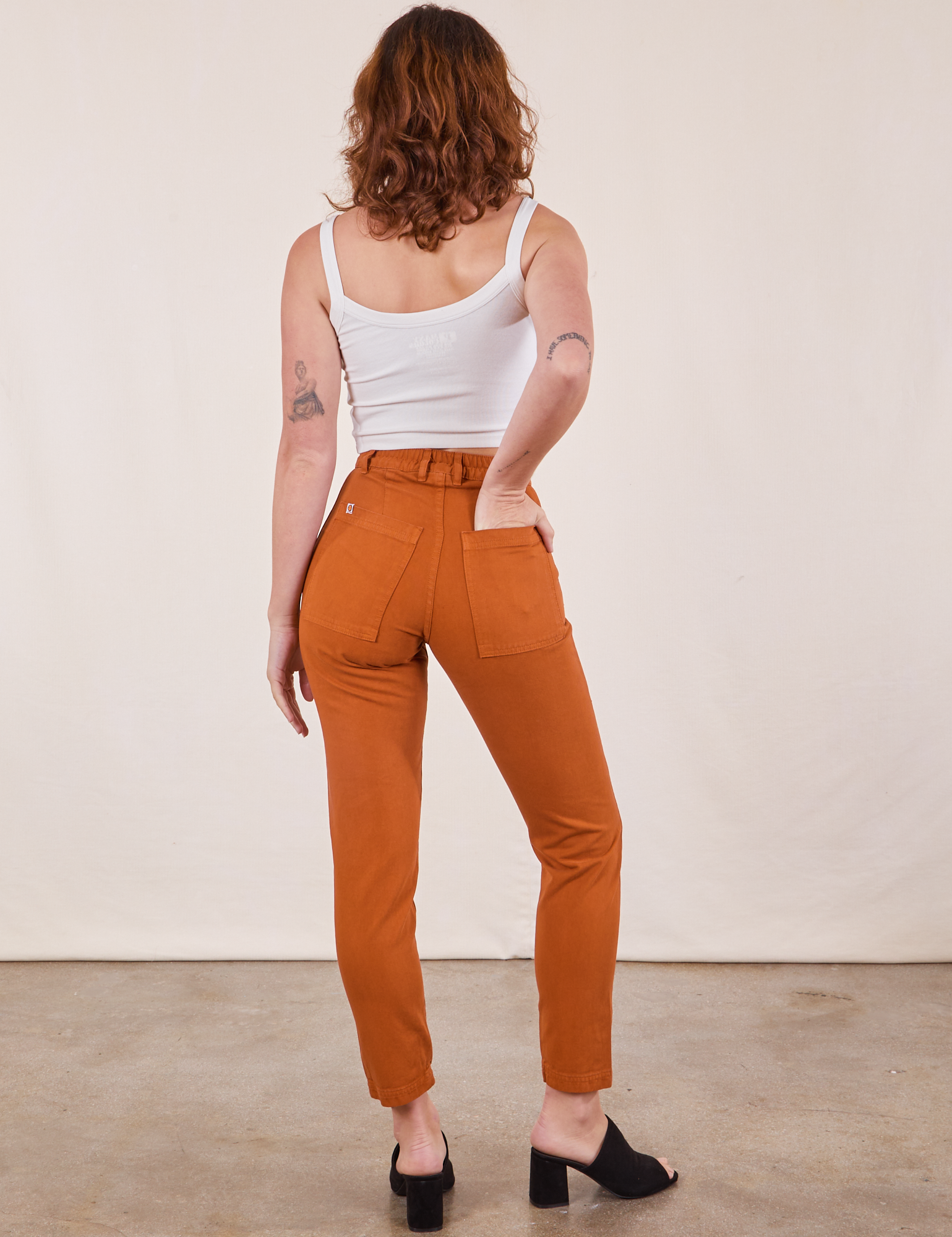 Back view of Pencil Pants in Burnt Terracotta and Cropped Cami in vintage tee off-white on Alex