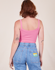 Back view of Cropped Cami in Bubblegum Pink and light wash Frontier Jeans worn by Alex
