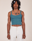 Jerrod is 6'3" and wearing S Cropped Cami in Marine Blue paired with vintage tee off-white Western Pants
