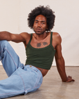 Jerrod is wearing Cropped Cami in Swamp Green and light wash Carpenter Jeans