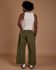 Back view of Drop Pocket Cargo Pants in Surplus Green and Tank Top in vintage tee white on Jerrod