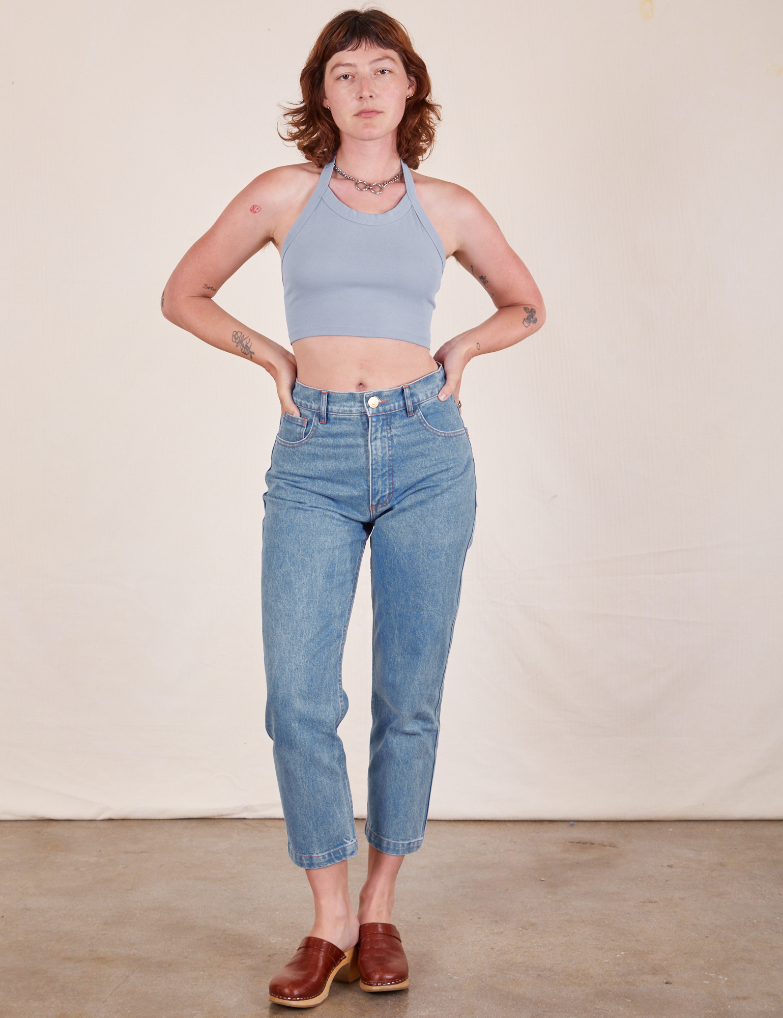Alex is wearing Halter Top in Periwinkle and light wash Frontier Jeans