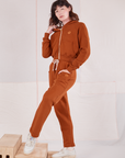 Alex is 5'8" and wearing P Cropped Zip Hoodie in Burnt Terracotta paired with matching Rolled Cuff Sweat Pants