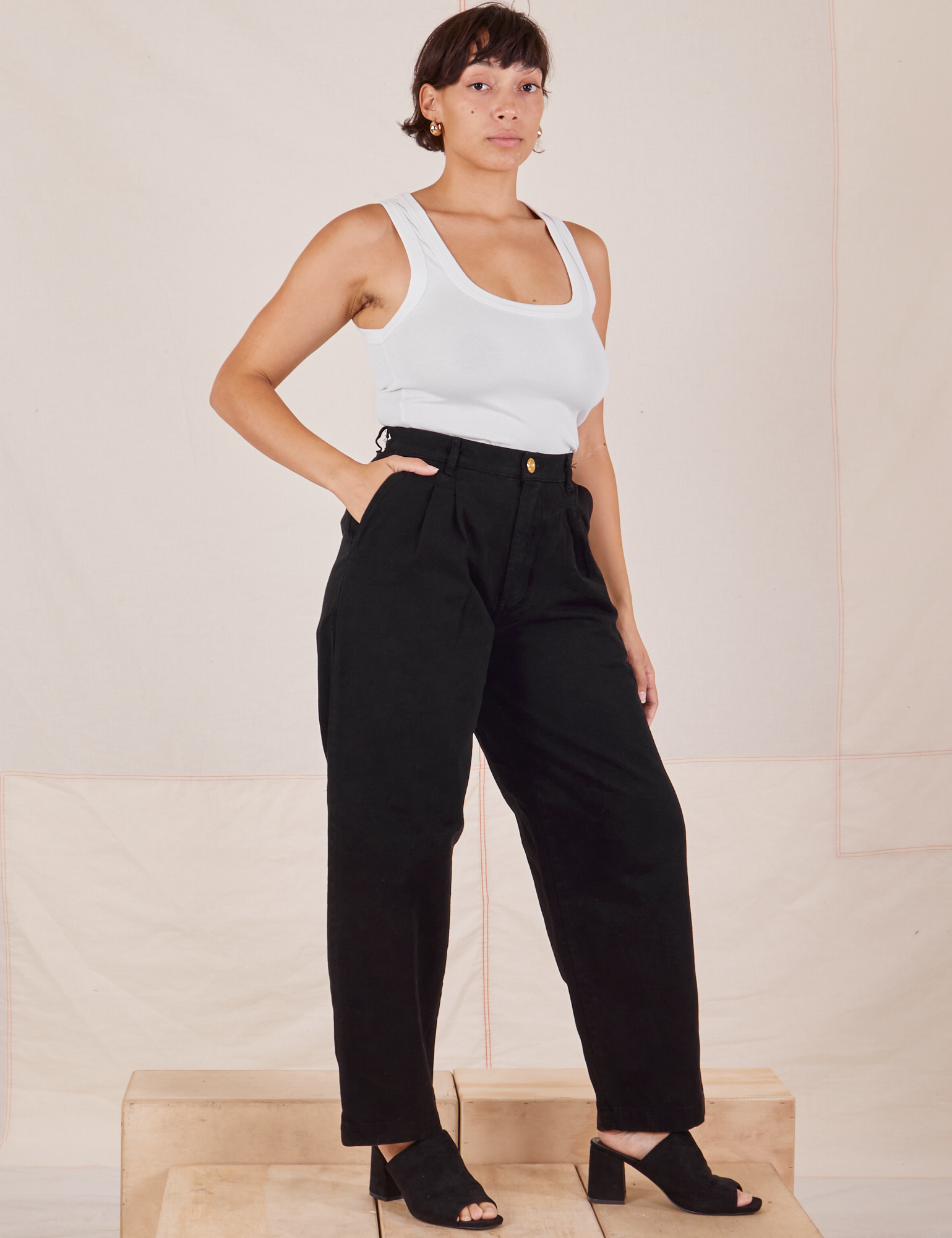 Angled view of Heavyweight Trousers in Basic Black and Cropped Tank Top in vintage tee off-white