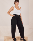 Angled view of Heavyweight Trousers in Basic Black and Cropped Tank Top in vintage tee off-white