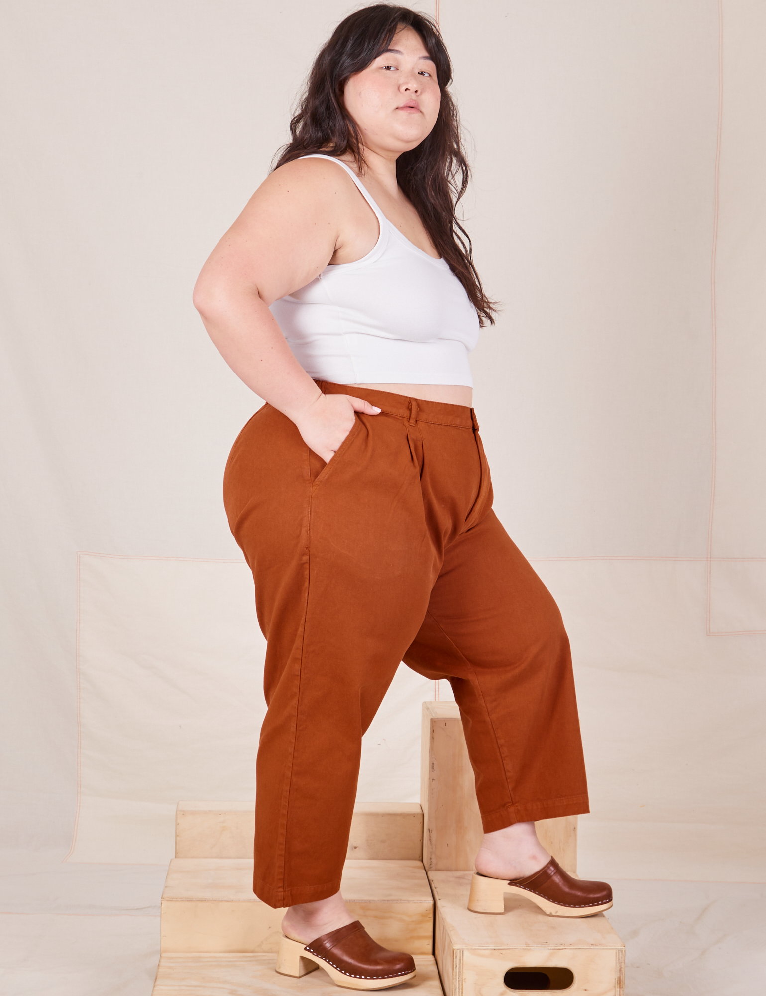 Side view of Heavyweight Trousers in Burnt Terracotta and Cropped Cami in vintage tee off-white worn by Ashley