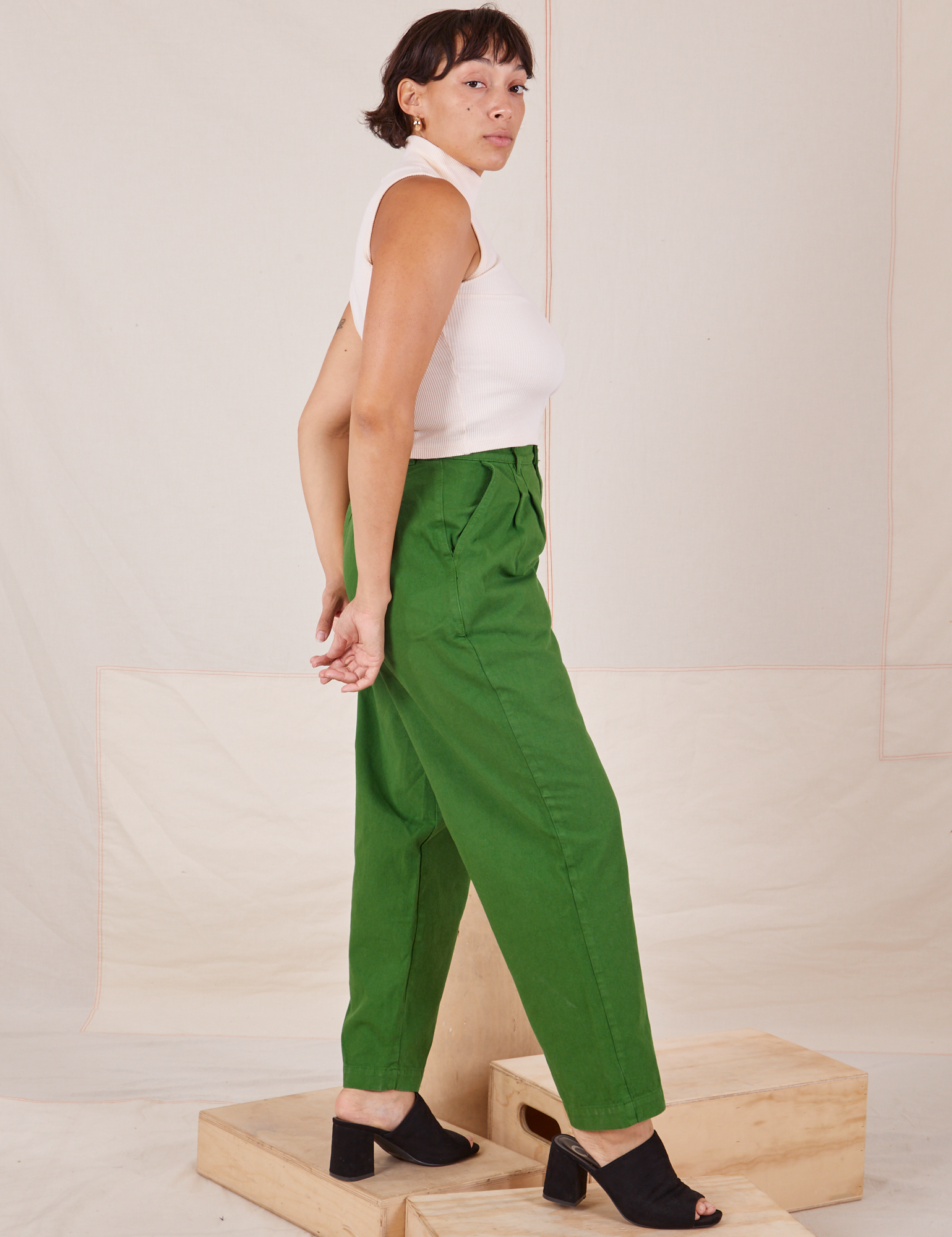 Side view of Heavyweight Trousers in Lawn Green and Sleeveless Turtleneck in vintage tee off-white worn by Tiara
