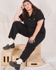 Katie is wearing Heritage Short Sleeve Jumpsuit in Basic Black
