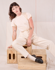 Alex is wearing Heritage Trousers in Natural  and Organic Vintage Tee in vintage tee off-white.