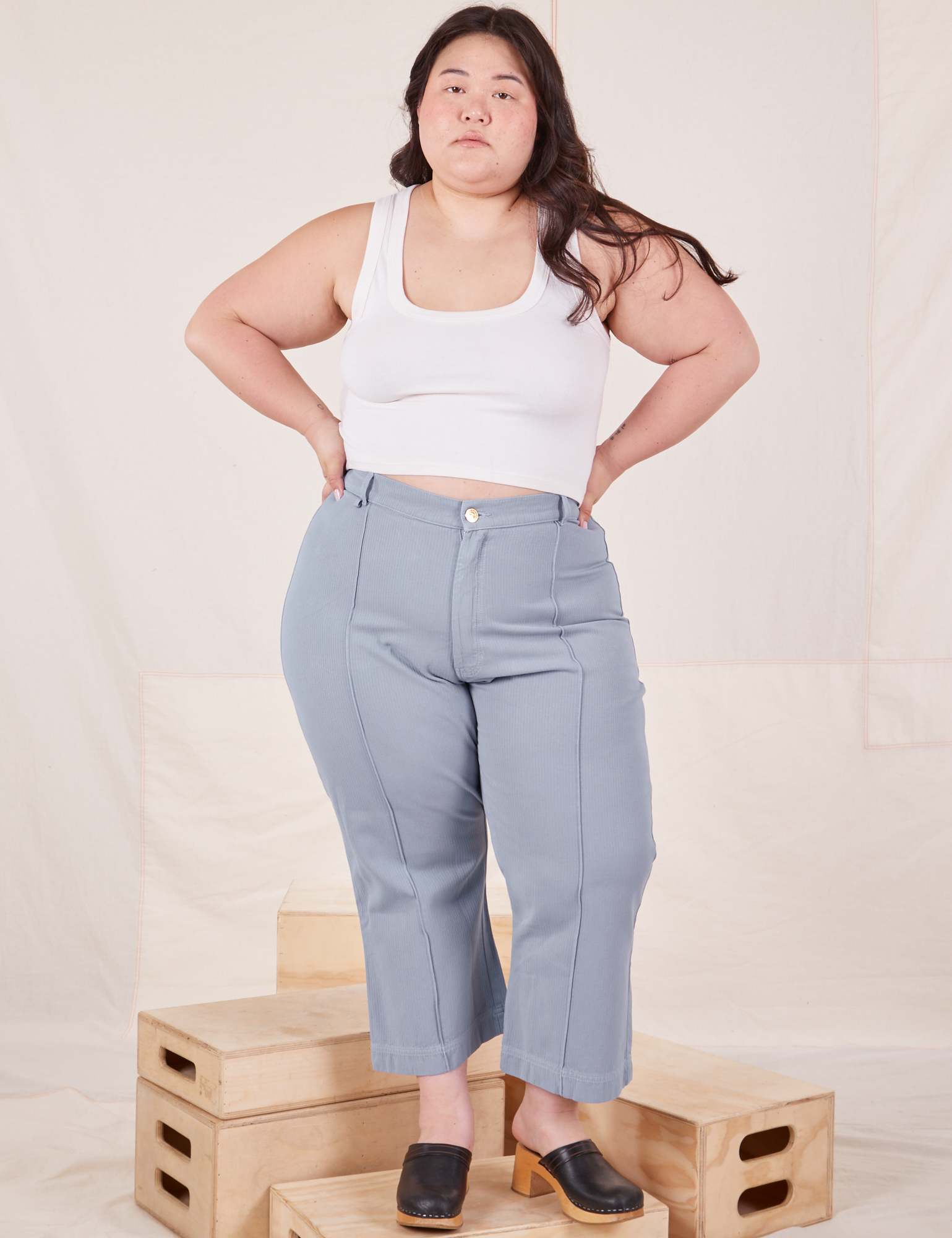 Ashley is 5&#39;7&quot; and wearing 1XL Petite Heritage Westerns in Periwinkle paired with Cropped Tank Top in vintage tee off-white