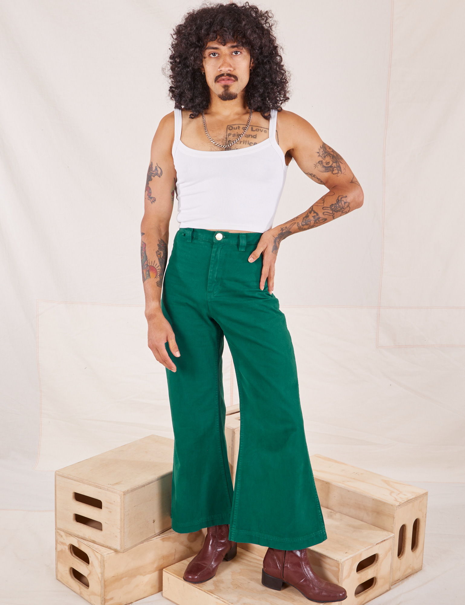 Jesse is 5&#39;8&quot; and wearing XXS Bell Bottoms in Hunter Green paired with vintage off-white Cami