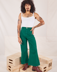 Jesse is 5'8" and wearing XXS Bell Bottoms in Hunter Green paired with Cropped Cami in vintage tee off-white