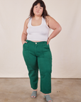 Ashley is 5'7" and wearing 1XL Petite Work Pants in Hunter Green paired with Cropped Tank Top in vintage tee off-white