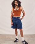 Jesse is 5'8" and wearing S Carpenter Shorts in Dark Wash paired with a burnt terracotta Cropped Tank