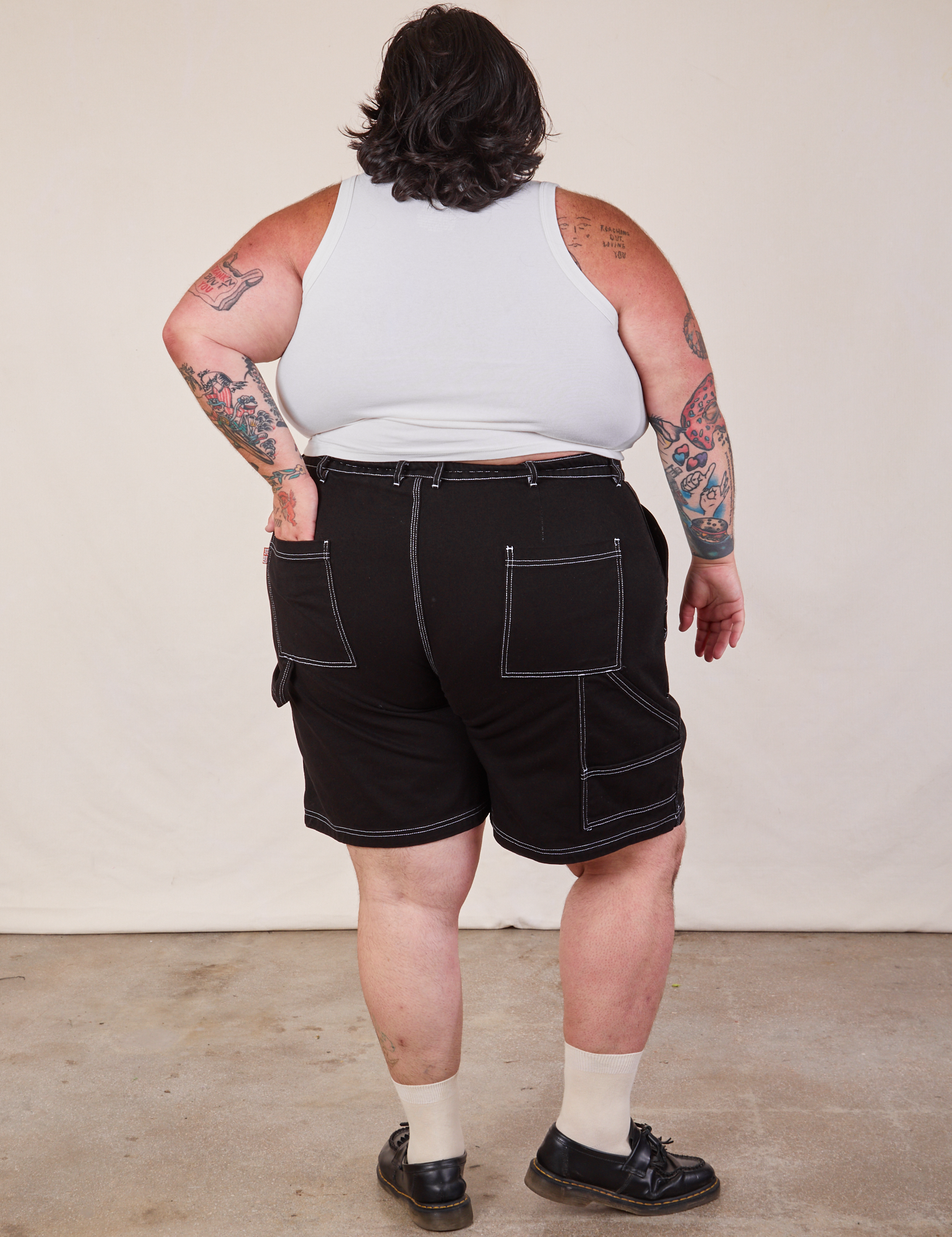 Back view of Carpenter Shorts in Basic Black and Cropped Tank in vintage tee off-white on Sam