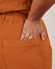 Back close up of Short Sleeve Jumpsuit in Burnt Terracotta worn by Morgan