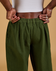Baggy Mid-Rise Trousers in Evergreen back close up on Jerrod