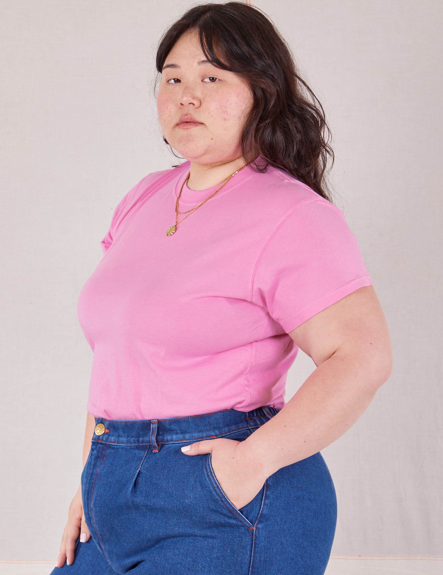 Angled front view of Organic Vintage Tee in Bubblegum Pink tucked into dark wash Trouser Jeans on Ashley
