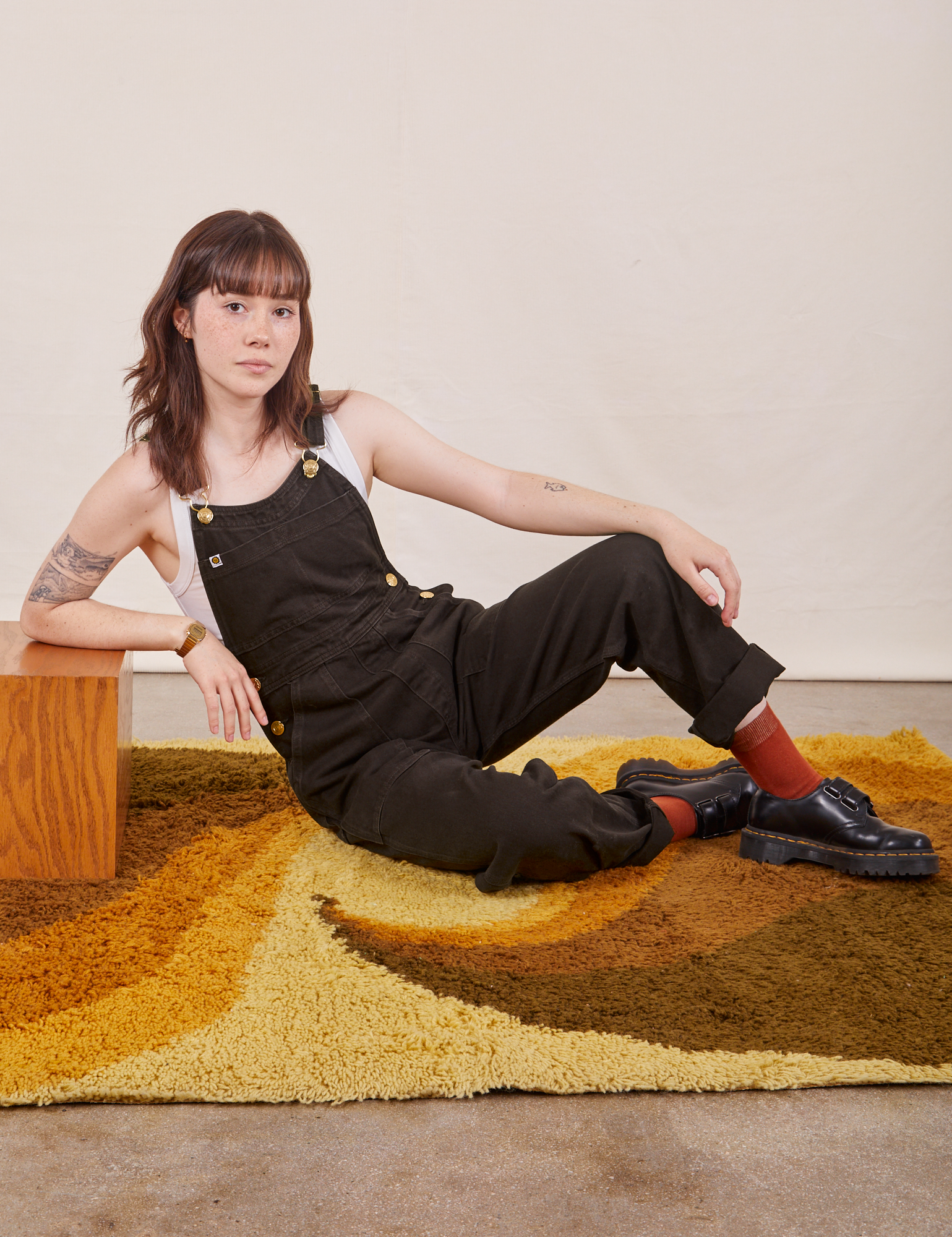Hana is wearing Original Overalls in Mono Espresso with a Cropped Tank Top in vintage tee off-white underneath.