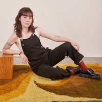 Hana is wearing Original Overalls in Mono Espresso with a vintage off-white Cropped Tank Top underneath.