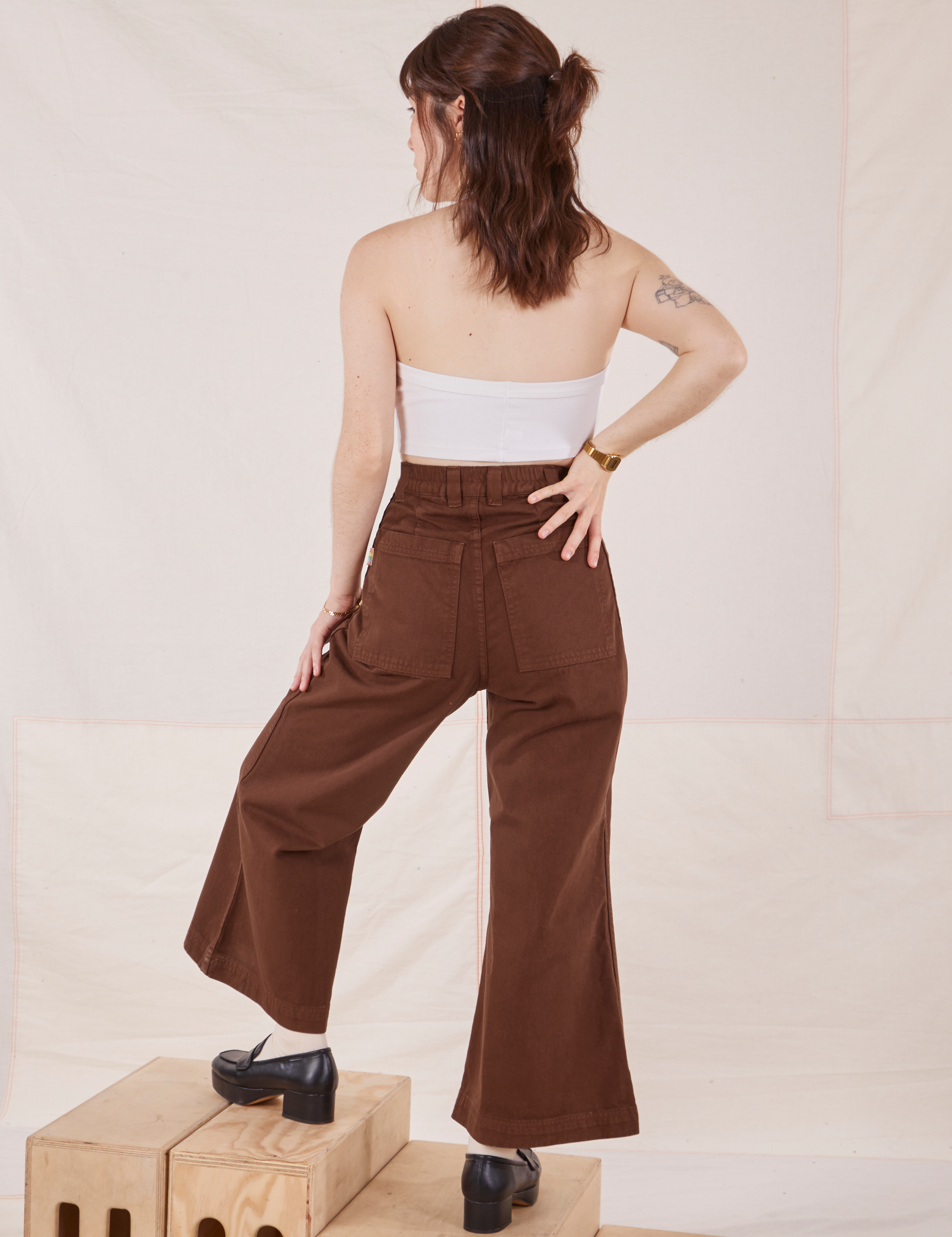 Back view of Petite Bell Bottoms in Fudgesicle Brown and Halter Top in vintage tee off-white