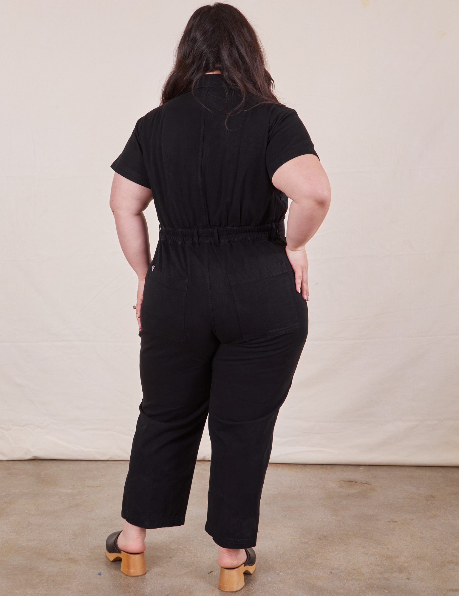 Petite Short Sleeve Jumpsuit in Basic Black back view close up worn by Ashley