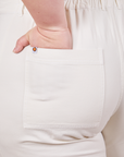 Back pocket close up of Petite Short Sleeve Jumpsuit in Vintage Tee Off-White. Ashley had her hand in the pocket.