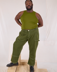Elijah is 6’4” and wearing 3XL Railroad Carpenter Jeans in Summer Olive paired with a summer olive Muscle Tee
