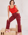 Tiara is 5'4" and wearing S Railroad Carpenter Jeans in Mustang Red paired with mustang red Square Neck Tank
