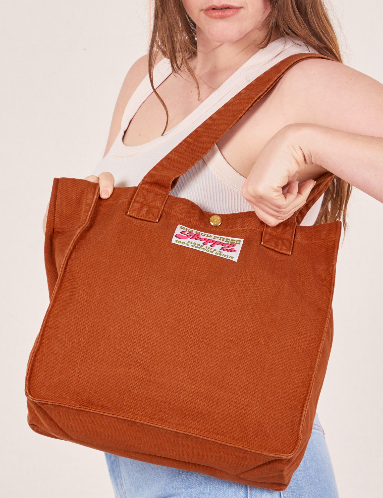 Shopper Tote Bag in Burnt Orange worn as a shoulder bag on Allison
