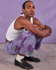 Jerrod is wearing Paintstamped Work Pants in Grape and Cropped Tank in Vintage Tee Off-White