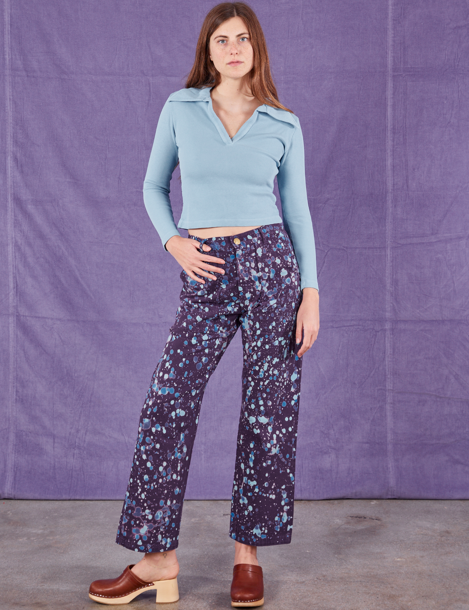 Scarlett is 5&#39;9&quot; and wearing XS Marble Splatter Work Pants in Nebula Purple paired with baby blue Long Sleeve Fisherman Polo